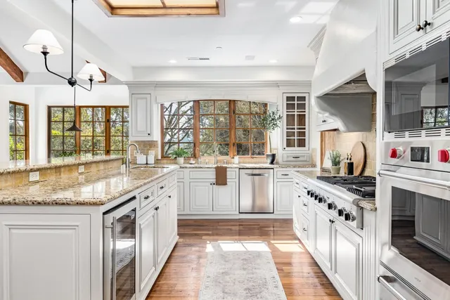 a white stove top oven sitting inside of a kitchen