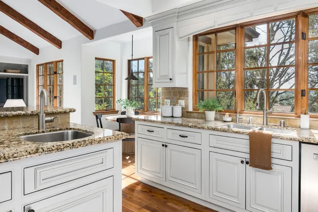 a view of a dining room with furniture large windows and wooden floor