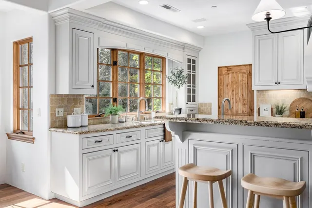a view of a hallway with wooden floor and a livingroom