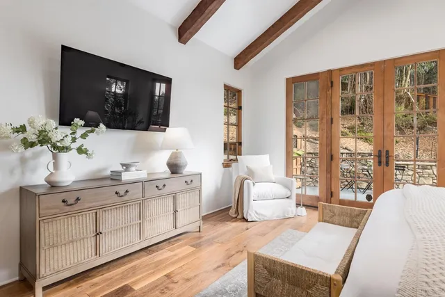 a bedroom with a bed and a painting on the wall