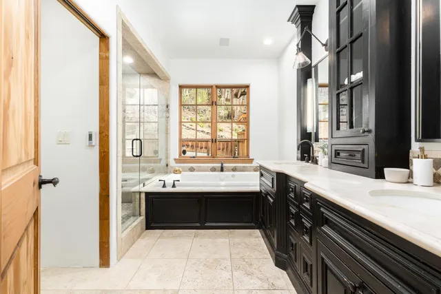a bathroom with a tub sink and shower