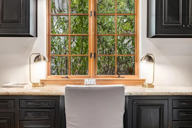 a kitchen with granite countertop wooden cabinets and a stove top oven