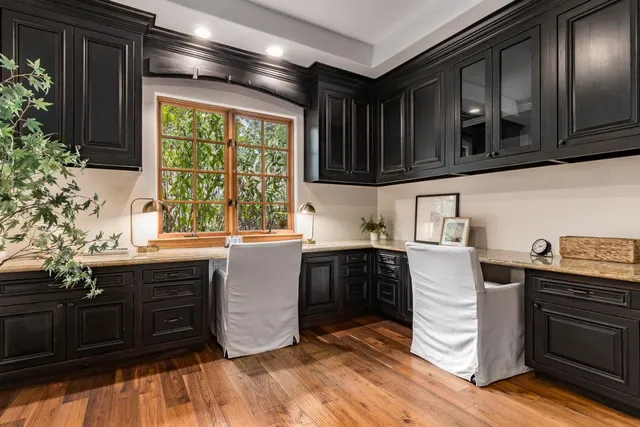 a bedroom with a bed a mirror and desk