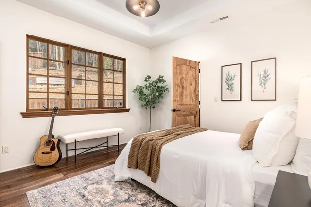 a bedroom with a bed and a potted plant