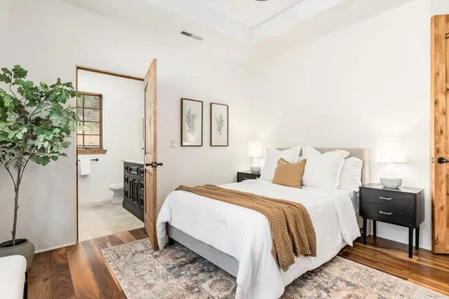 a bedroom with two beds and a large window