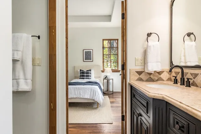 a bathroom with a double vanity sink and a mirror