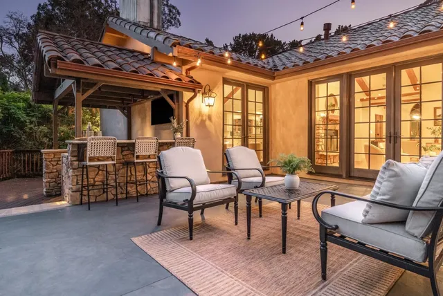 a living room with furniture and a floor to ceiling window