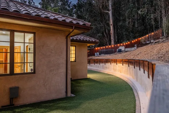 a view of a house with a yard and sitting area
