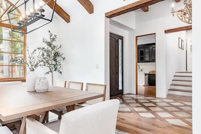 a living room with furniture a dining table and wooden floor
