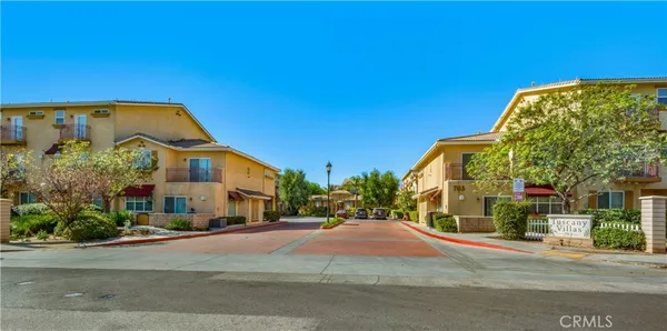 a view of a blue house with a street