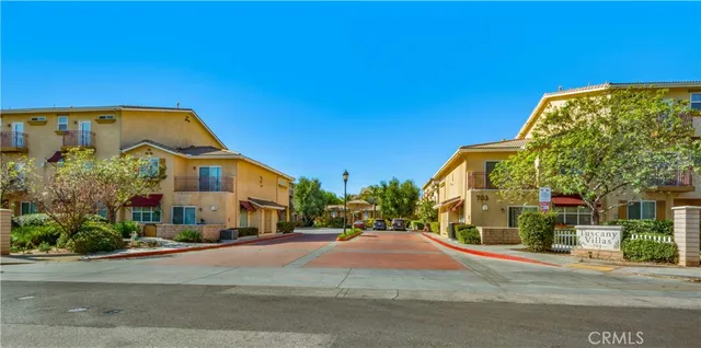 a view of a blue house with a street