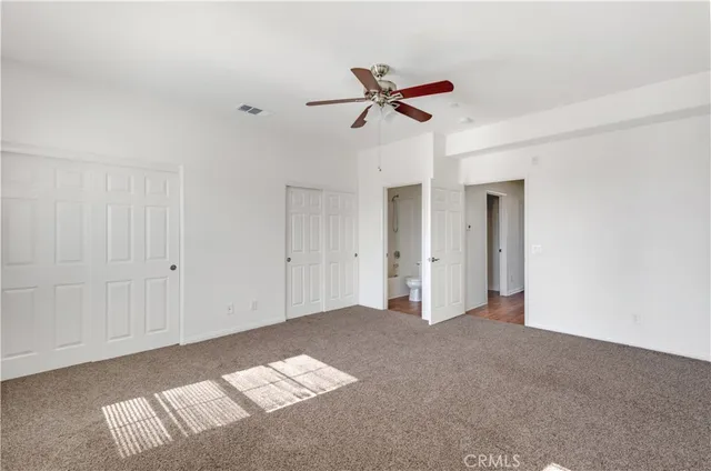 a kitchen with a refrigerator a sink and dishwasher with wooden floor
