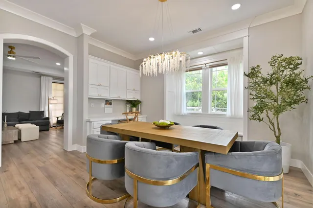 a large kitchen with stainless steel appliances granite countertop a stove a sink dishwasher and a refrigerator with wooden floor