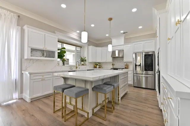a view of a dining room with furniture a chandelier and wooden floor