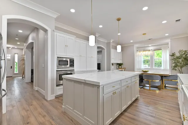 a kitchen with cabinets a sink and appliances