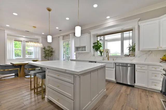 a spacious bedroom with a bed a flat screen tv and a couch