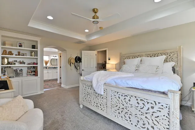 a view of a white house with a big yard and potted plants