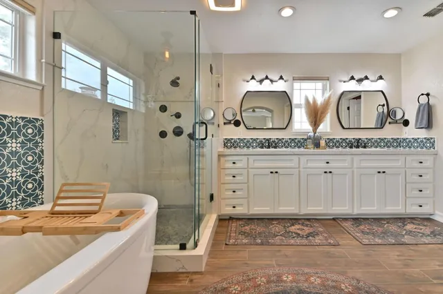 a living room with furniture a wooden floor and kitchen view