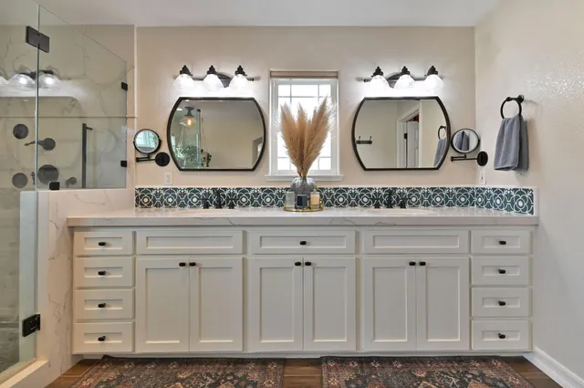 a kitchen with a refrigerator a stove top oven and cabinets