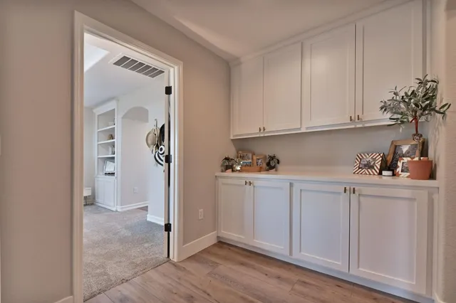 a living room with a bed furniture and a flat screen tv