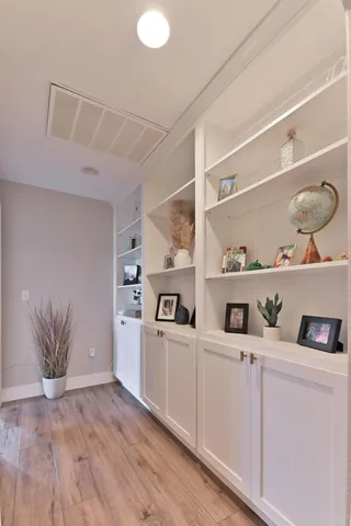 a bedroom with a bed and a dresser next to a window