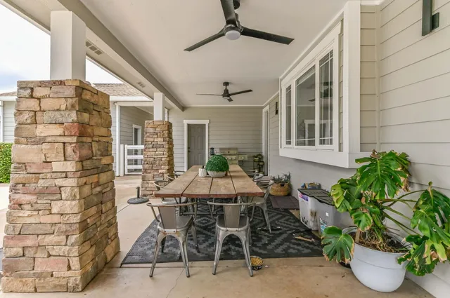 a view of a house with a yard and a pond