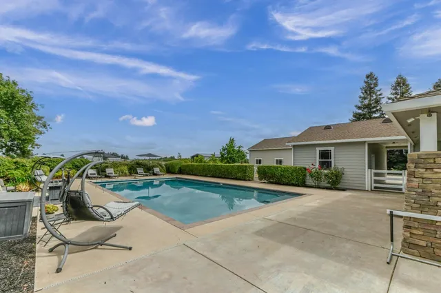 a view of swimming pool with seating area