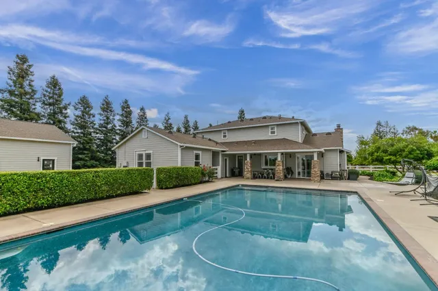 an aerial view of a house with a yard and lake view