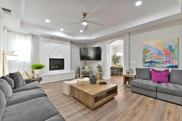 a living room with furniture and wooden floor