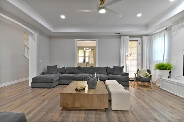a kitchen with kitchen island granite countertop a sink a stove and a wooden floors