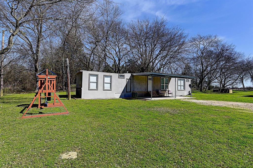 13324 County Road 352 Terrell, TX 75161 - Photo 1 of 1 a view of a house with a backyard and a tree