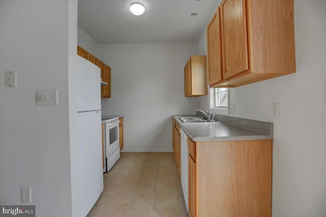 a utility room with cabinets washer and dryer