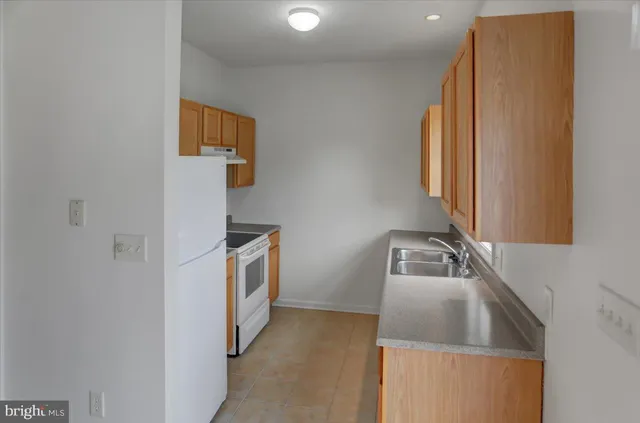 a kitchen that has a sink and a stove in it