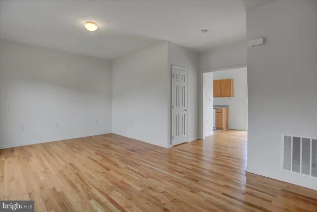 a view of an empty room and wooden floor