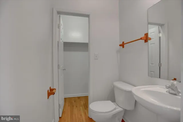 a white toilet sitting next to a bathroom sink