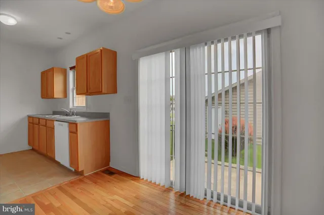 a view of a room with wooden floor and cabinet