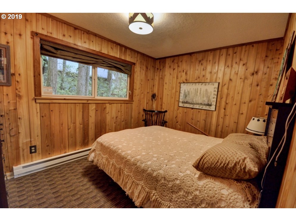 75191 East E Road Rhododendron, OR 97049 - Photo 18 of 32 a bedroom with a bed and a window