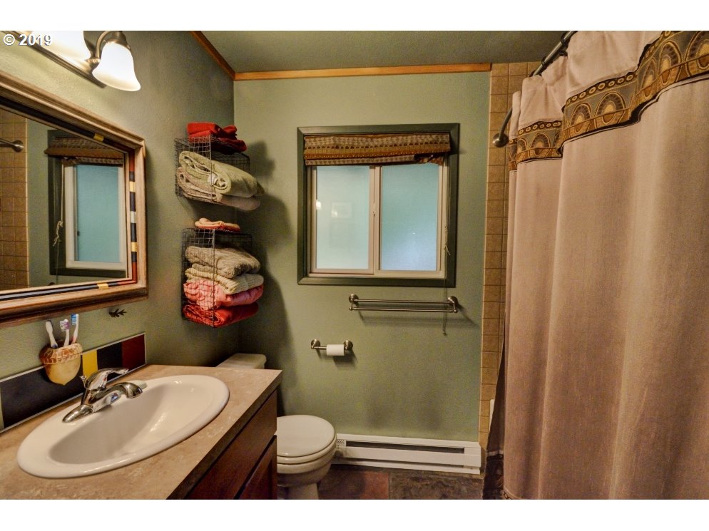 75191 East E Road Rhododendron, OR 97049 - Photo 26 of 32 a bathroom with a sink mirror vanity and toilet