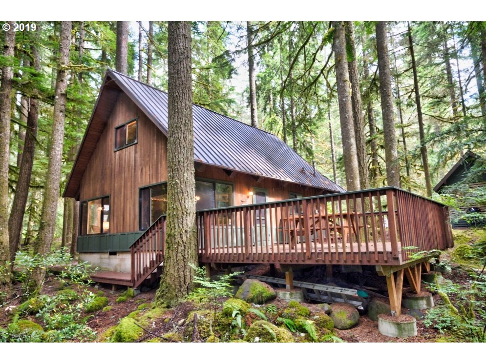 75191 East E Road Rhododendron, OR 97049 - Photo 30 of 32 a view of a small house with wooden deck and furniture
