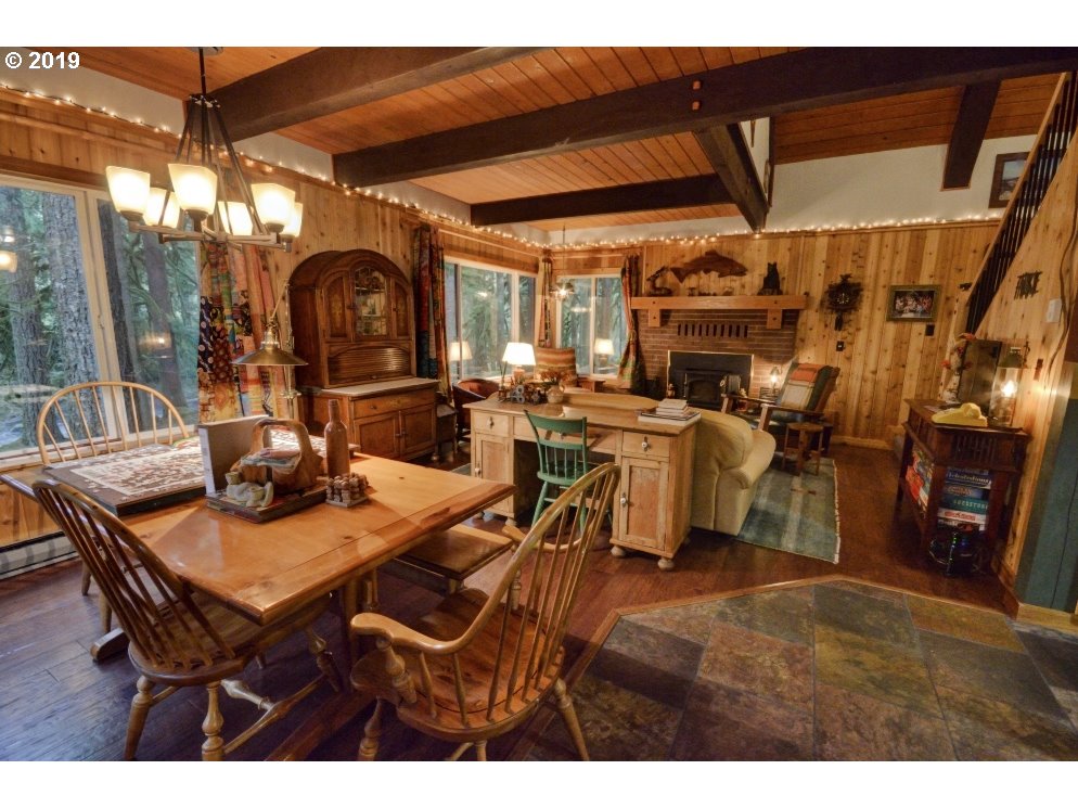 75191 East E Road Rhododendron, OR 97049 - Photo 10 of 32 a view of a dining room with furniture and chandelier