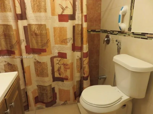 a bathroom with a shower and a toilet