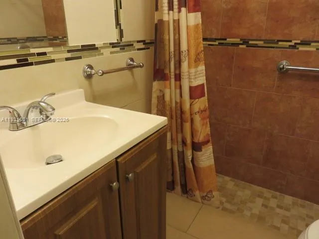 an empty room with white walls and tiles