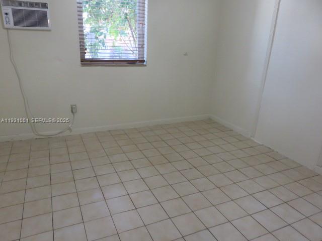 2820 Southwest 16th Terrace, Unit EFF Miami, FL 33145 - Photo 6 of 8 an empty room with white walls and tiles