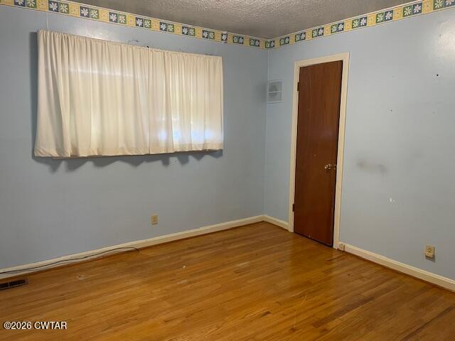 115 Barker Road Atwood, TN 38220 - Photo 13 of 16 an empty room with wooden floor and windows