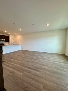 2136 Bodega Road, Unit 2136 Oswego, IL 60543 - Photo 8 of 19 an empty room with wooden floor