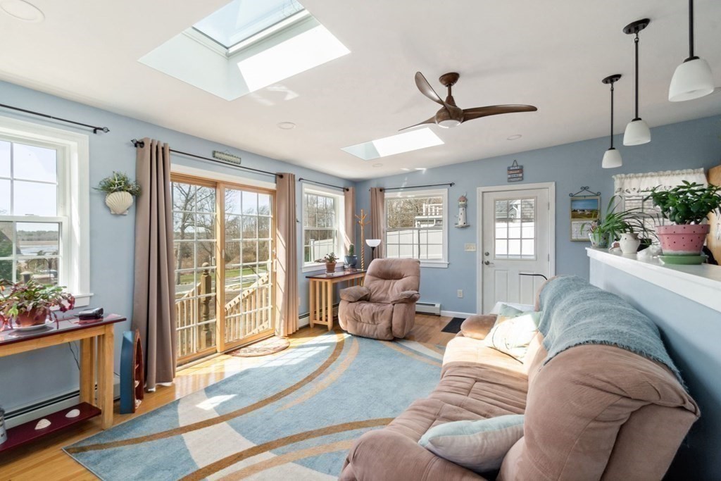 58 Converse Road Marion, MA 02738 - Photo 12 of 18 a living room with furniture and a floor to ceiling window