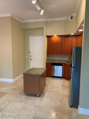 a kitchen with stainless steel appliances a refrigerator and a microwave
