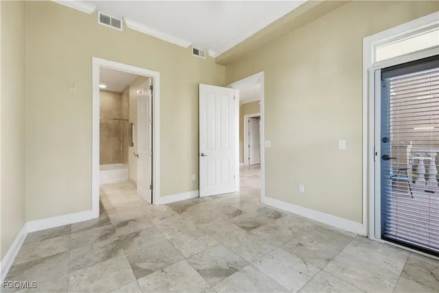 an empty room with windows and closet