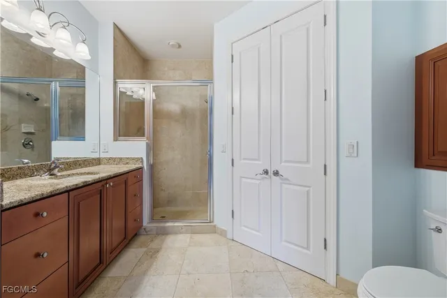 a view of a room that has a bed and a chair with the glass door