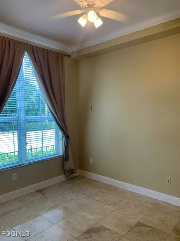 an empty room with a fireplace and windows